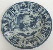 A collection of 18th Century Delft plates including a Kraak style shallow dish with figural panel