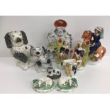 A collection of Staffordshire Pottery wares including two black and white spaniels,
