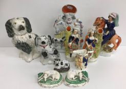 A collection of Staffordshire Pottery wares including two black and white spaniels,