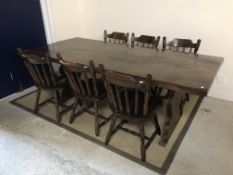 A 20th Century oak refectory style dining table, the single piece top on end trestle supports,