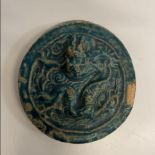 A Chinese turquoise glazed terracotta medallion decorated with a dragon, 12.