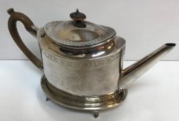 A George III silver teapot with wooden handle,