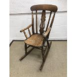 A late 19th Century Windsor style rocking chair, 106 cm high,