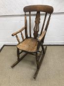 A late 19th Century Windsor style rocking chair, 106 cm high,