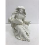 An 18th Century Bow figure blanc de chine study of "A nun seated reading",