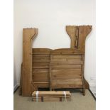 A pair of 20th Century pine bedsteads, the headboards approx 130 cm high,