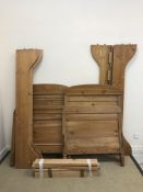 A pair of 20th Century pine bedsteads, the headboards approx 130 cm high,