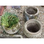 A collection of four reconstituted stone garden planters