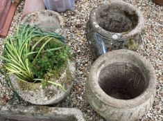 A collection of four reconstituted stone garden planters