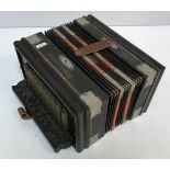 An ebonised cased "The Winner" tremolo piano accordion with steel bronze reeds,