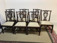 A set of seven mahogany framed Chippendale design dining chairs with carved and pierced back splat