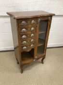 A 20th Century mahogany and brass and porcelain embellished side cabinet in the Louis XV taste with