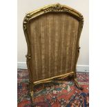 A 19th Century carved giltwood framed adjustable fire screen formerly with silkwork panels,