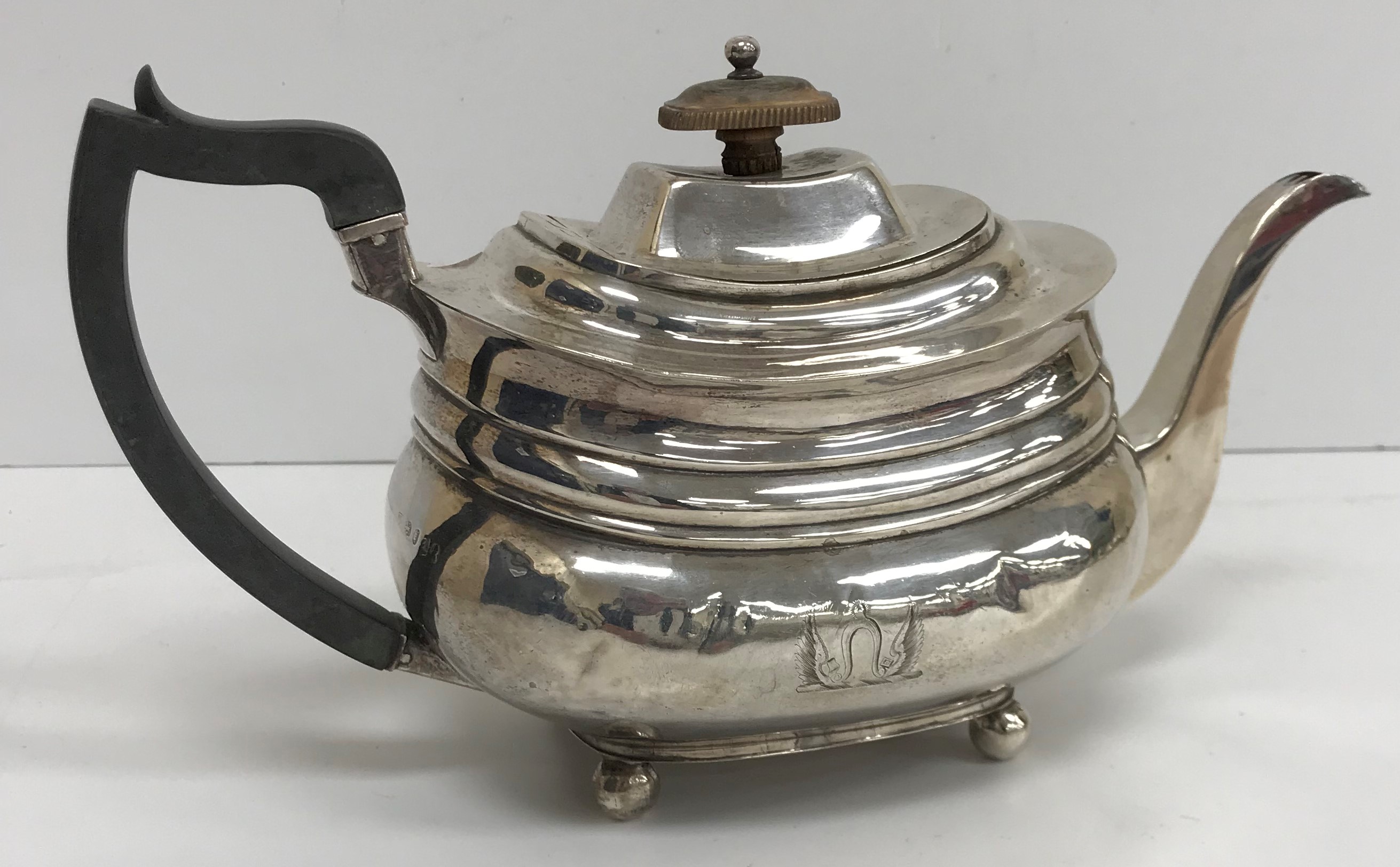 A late George III silver teapot of rectangular bellied form (maker's marks rubbed, London 1816),