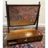 A Regency mahogany toilet mirror, the rectangular plate on square supports,