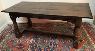 An early 20th Century oak refectory style dining table in the 18th Century manner,