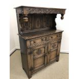 An oak court cupboard attributed to Titchmarsh & Goodwin in the Lake District style,