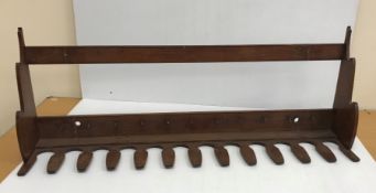An early 20th Century mahogany twelve section boot / whip rack,