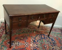A mahogany dressing table in the Regency style, the top with moulded edge above a slim drawer,