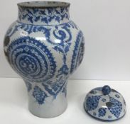 A 19th Century blue and white faience baluster shaped jar and cover in the Iznik style (several