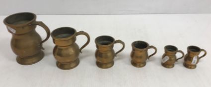 A graduated set of six Victorian brass measures including pint, half pint, gill,