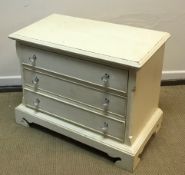 A modern cream painted chest of three drawers on bracket feet 85 cm wide x 46 cm deep x 65.