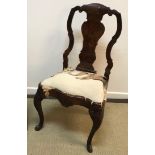 An 18th Century walnut dining chair in the Dutch taste with vase shaped back splat over a drop in