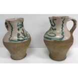 WITHDRAWN A pair of 19th Century part glazed terracotta baluster shaped jugs with scrolling foliate