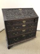 A Victorian carved oak bureau,