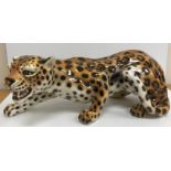 A modern Italian fireside pottery figure of a "Crouching leopard", approx 70cm long,