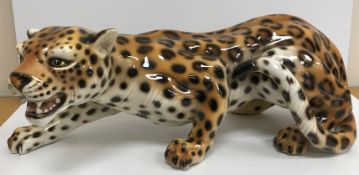 A modern Italian fireside pottery figure of a "Crouching leopard", approx 70cm long,