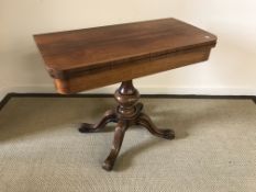 A Victorian rosewood fold-over card table on pedestal quadruped base and scroll feet,