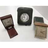 Three early 20th Century leather cased travel clocks,