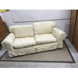 A modern upholstered scroll arm sofa with yellow loose covers, approx 244 cm wide, another similar,