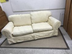 A modern upholstered scroll arm sofa with yellow loose covers, approx 244 cm wide, another similar,