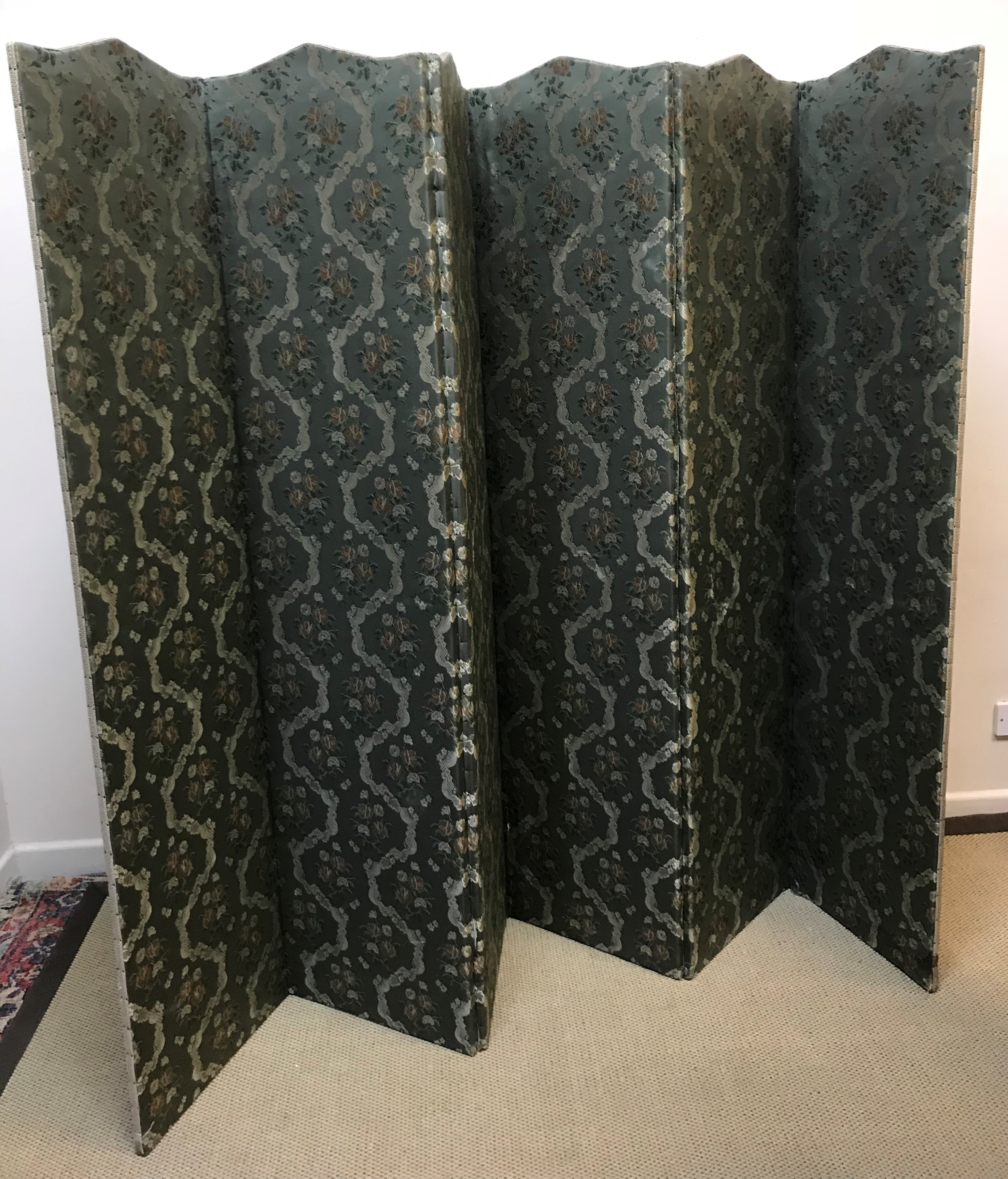 An early 20th Century floral upholstered six fold dressing screen 258 cm wide x 180 cm high