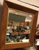 A 19th Century birds eye maple rectangular wall mirror with canted frame 61 cm x 54 cm