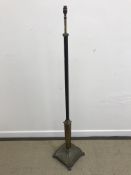 An early 20th Century painted iron and brass adjustable standard lamp in the Regency style,