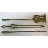 A set of three brass fire irons with flaming torch decorated handles, length of shovel 69.