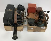 Two boxes of assorted mid 20th Century cameras and binoculars as well as a Voluma Dollond London No.