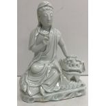 An 18th Century Chinese blanc de chine figure of "Guan Yin seated on the back of a recumbent