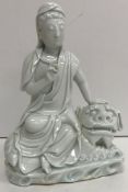 An 18th Century Chinese blanc de chine figure of "Guan Yin seated on the back of a recumbent