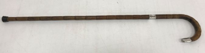 A bamboo effect walking stick with silver mounts 83 cm long including stopper