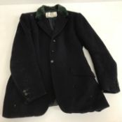 A navy hunt jacket with Cotswold Hunt buttons, green velvet collar,