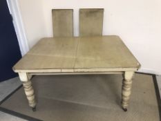 A Victorian extending dining table with two leaves, later painted,