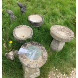 A collection of various stone and reconstituted stone ornaments including sundial, bird bath,