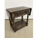 An oak single drawer drop leaf side table attributed to Titchmarsh & Goodwin,