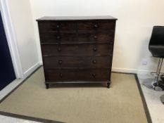 A Victorian mahogany chest of two short and four long drawers with turned knob handles raised on