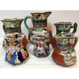 A set of four Masons ironstone chinoiserie pattern jugs with figural decoration and serpent handles