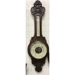 An oak cased barometer thermometer in the Victorian style with mercury farenheit and centigrade